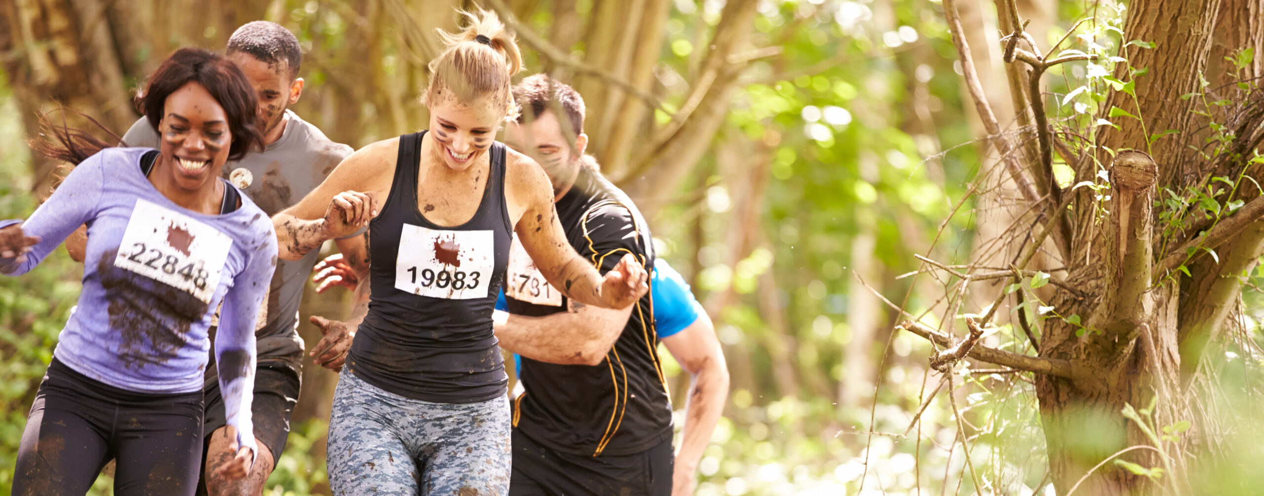 Competitors running in a forest at an endurance event